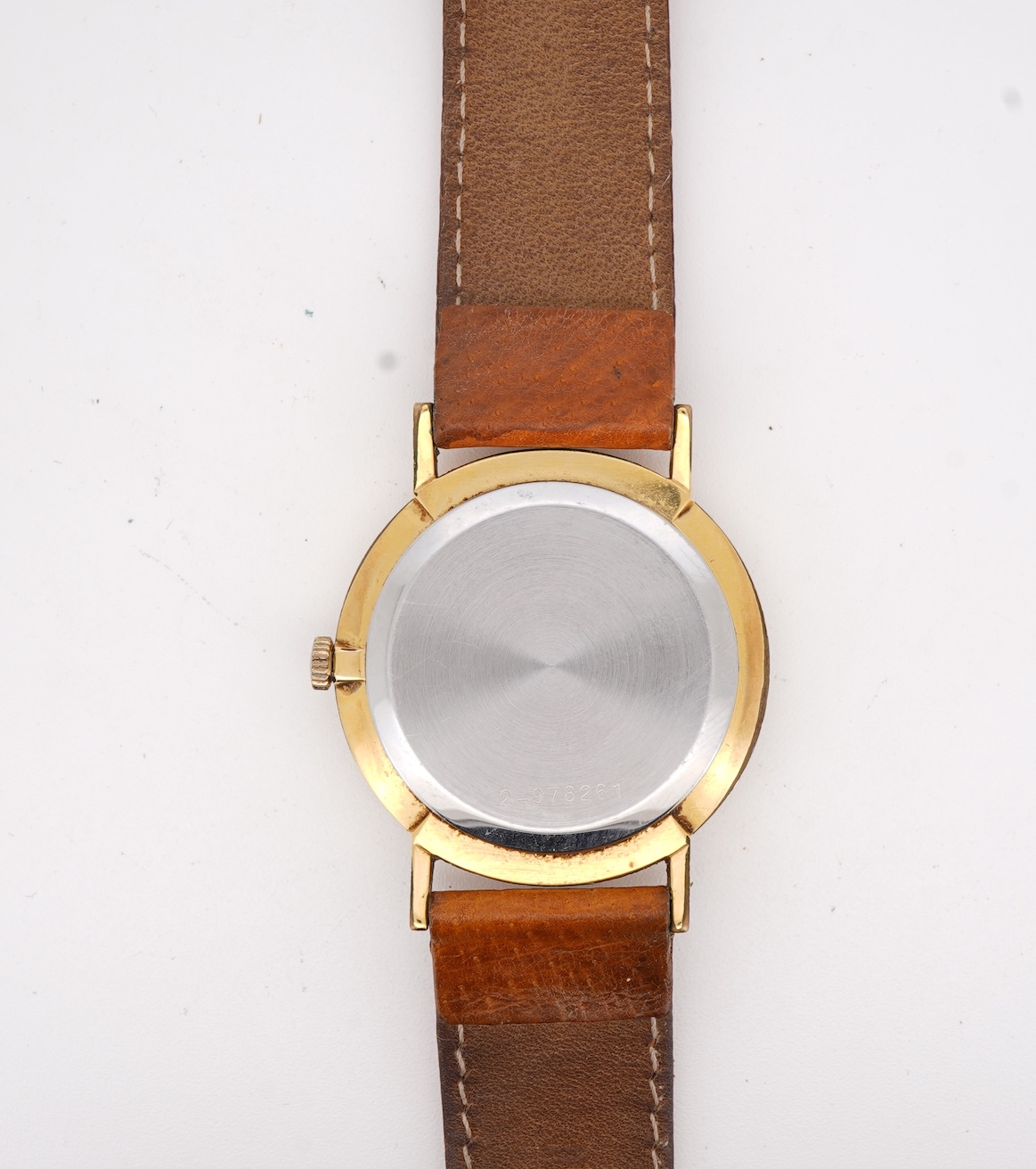 A gentleman's steel and gold plated Bulova Longchamp manual wind wrist watch, with baton numerals, case diameter 33mm, on a tanned leather strap.